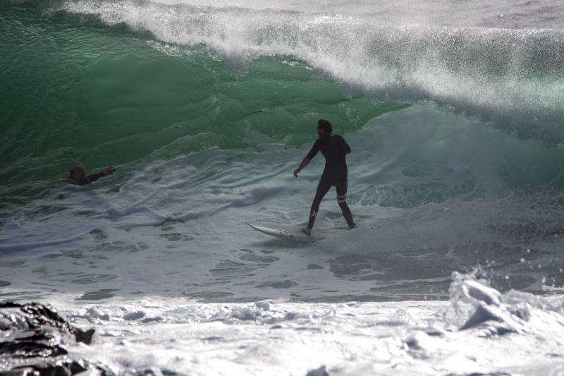 surfer standing up in barrel at dee why point